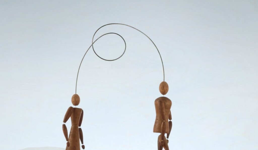 Human figurines connected with wire
