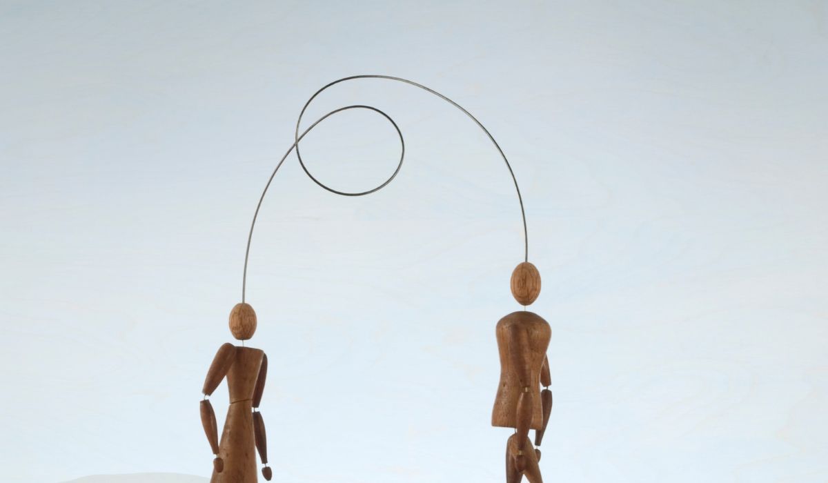 Human figurines connected with wire