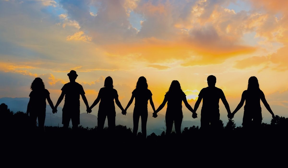 Group of people holding hands, trying to make a difference in the world.