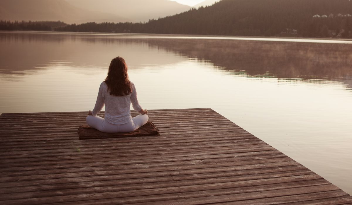 Woman meditating and connecting with her divine self.