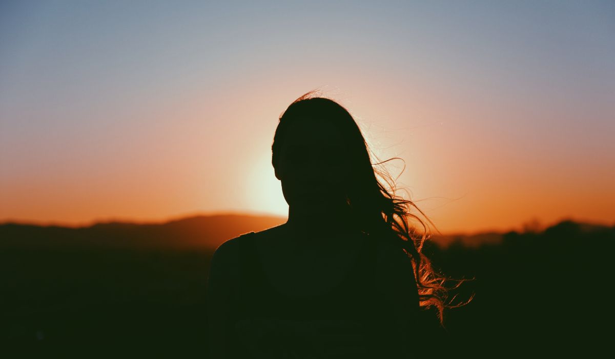 Woman's shadow against sunset