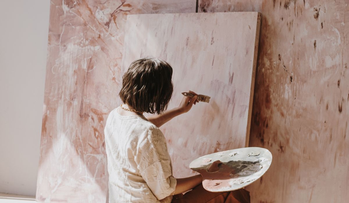 Woman accessing her creative self by painting.