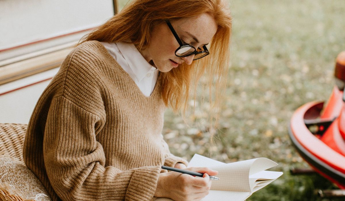 Woman recording her dreams in a journal.