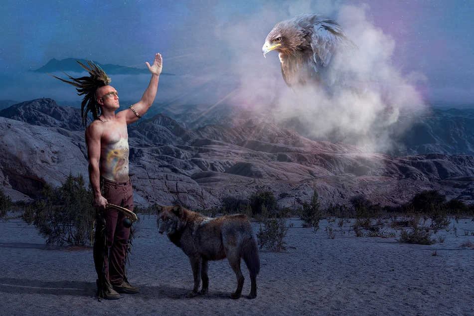 guy in a mohawk and a wolf looking at an eagle in the sky