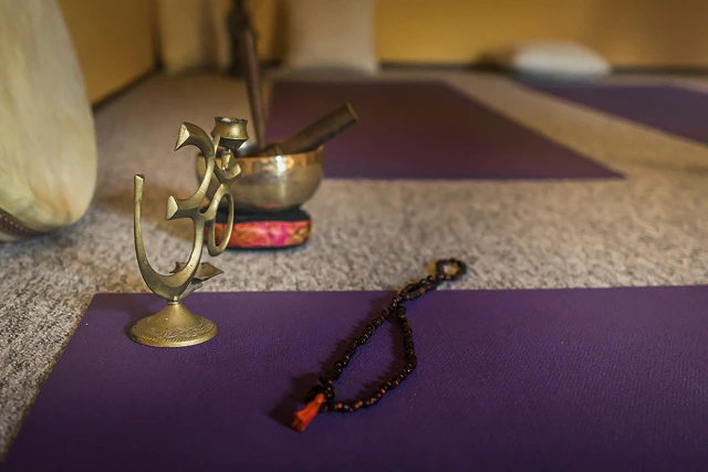 meditating tools above a yoga mat