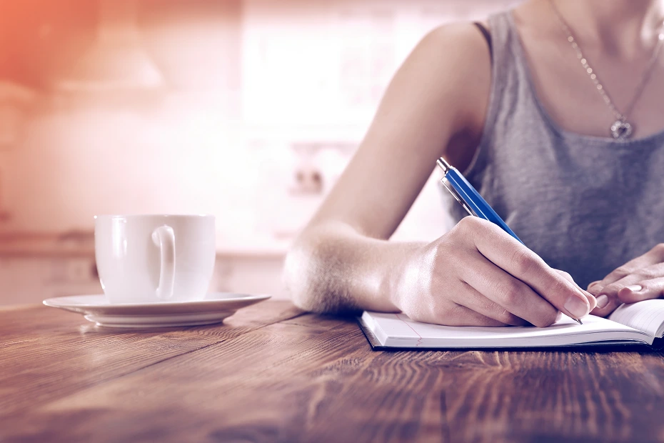 woman writing on her journal